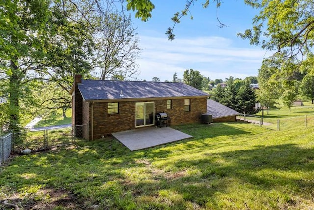5700 Academy Dr, Morristown, TN 37814 - back of property featuring a chimney, a patio, cooling unit, and brick siding