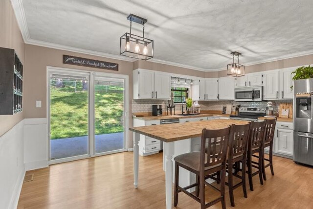 5700 Academy Dr, Morristown, TN 37814 - kitchen featuring appliances with stainless steel finishes, butcher block counters, a sink, white cabinetry, and crown molding