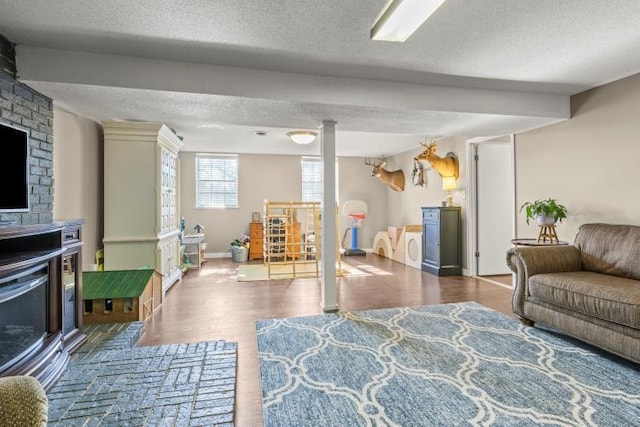 5700 Academy Dr, Morristown, TN 37814 - recreation room featuring a fireplace, a textured ceiling, wood finished floors, and baseboards