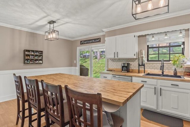 5700 Academy Dr, Morristown, TN 37814 - kitchen with a sink, butcher block counters, stainless steel dishwasher, white cabinets, and decorative backsplash