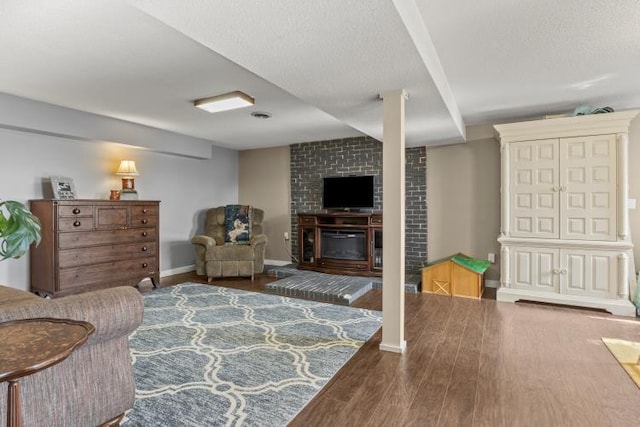 5700 Academy Dr, Morristown, TN 37814 - living room with wood finished floors, baseboards, a large fireplace, and a textured ceiling