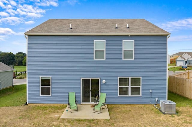 back of house with a lawn, a patio area, and central air condition unit