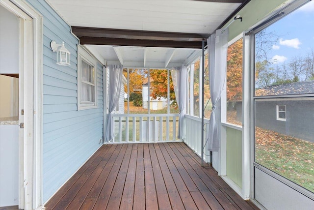 unfurnished sunroom with beamed ceiling