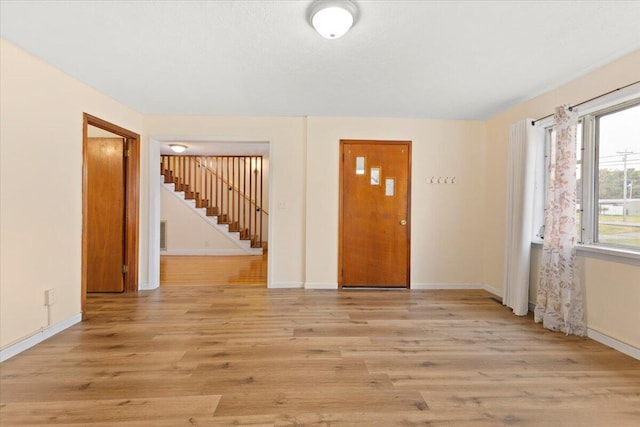 unfurnished room with light wood-type flooring