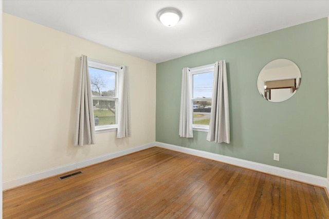 unfurnished room featuring hardwood / wood-style flooring