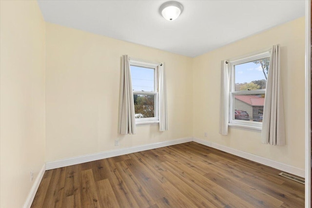 unfurnished room featuring hardwood / wood-style flooring