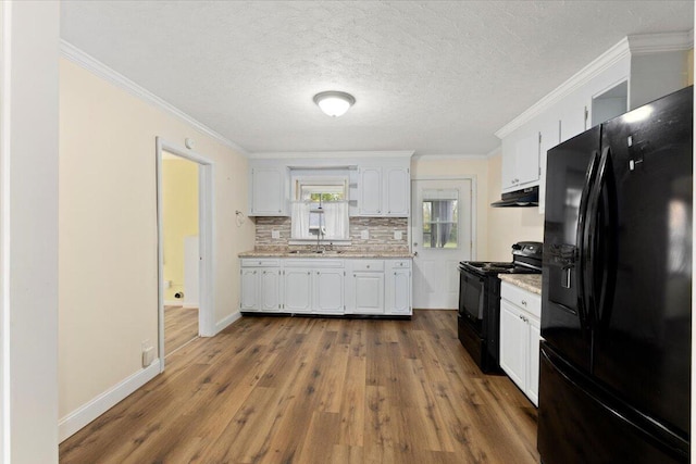 kitchen with black appliances, white cabinets, sink, dark hardwood / wood-style floors, and tasteful backsplash