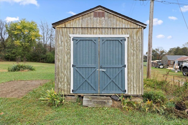 view of outbuilding with a lawn