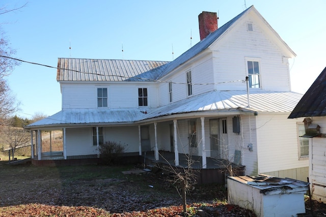 back of property with a porch