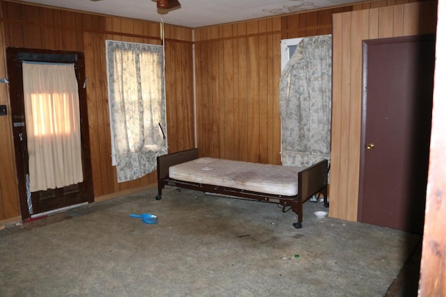 interior space with carpet flooring and wood walls