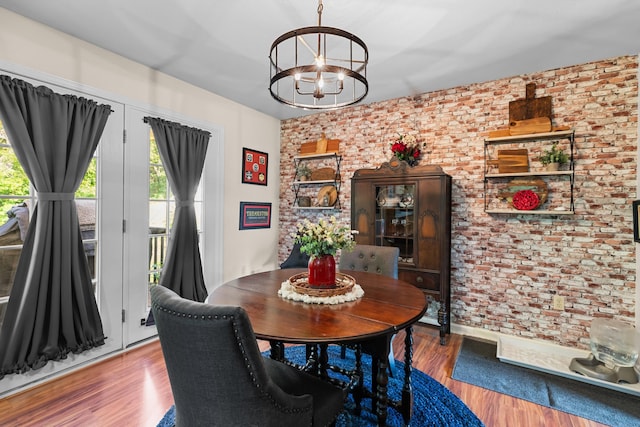 3912 Isaac Ave, Morristown, TN 37814 - dining space with a chandelier, wood finished floors, and brick wall
