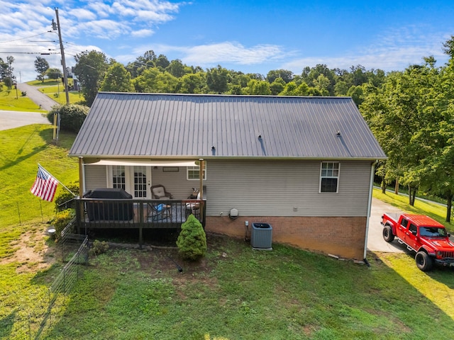 3912 Isaac Ave, Morristown, TN 37814 - rear view of house with metal roof, a yard, a wooden deck, and central AC