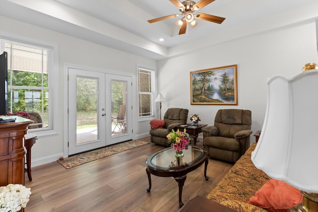 living room featuring ceiling fan, light wood-type flooring, and french doors