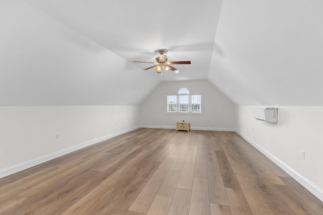 bonus room with ceiling fan, light hardwood / wood-style flooring, and vaulted ceiling