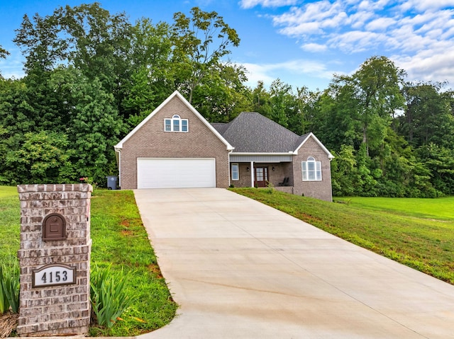 front facade with a garage and a front lawn