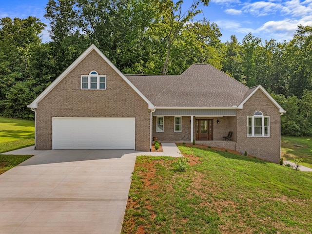 view of front of home featuring a porch, a garage, and a front yard