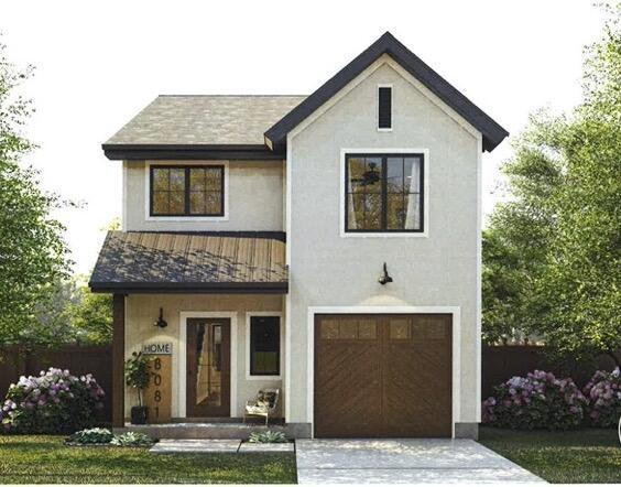 view of front of home with a standing seam roof, stucco siding, and metal roof
