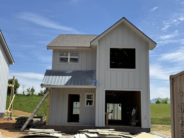 view of front of home with a standing seam roof, stucco siding, and metal roof