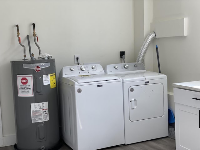 laundry room featuring washing machine and clothes dryer, electric water heater, and light hardwood / wood-style floors