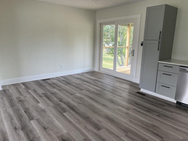 unfurnished dining area with visible vents, light wood-style flooring, and baseboards