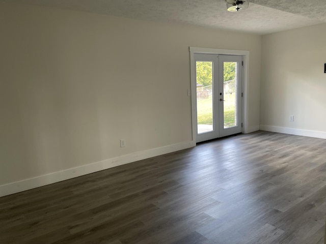 unfurnished room with french doors, baseboards, a textured ceiling, and dark wood-style flooring