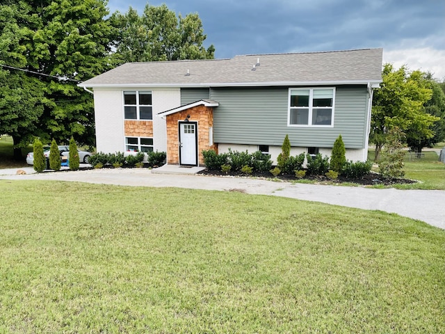 raised ranch featuring a front yard