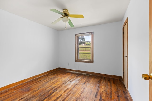 unfurnished room with ceiling fan and dark wood-type flooring