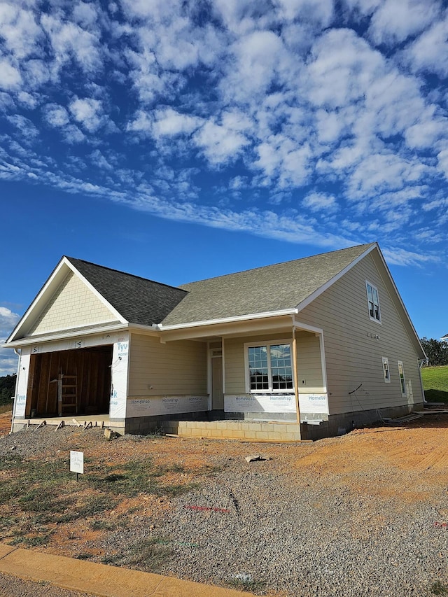 view of front of home featuring covered porch and a garage