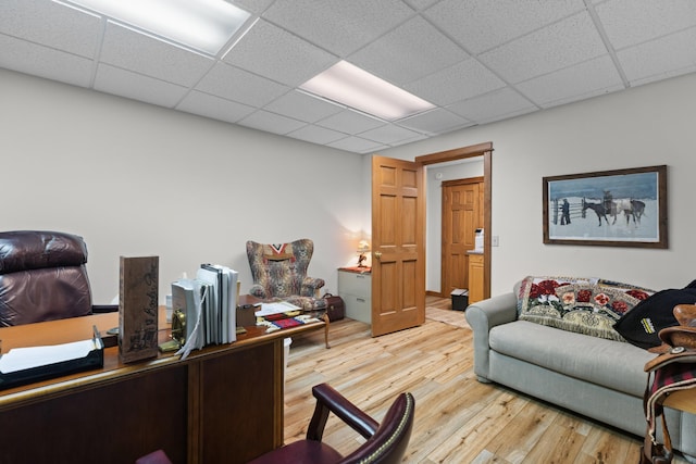 office space with wood finished floors and a paneled ceiling