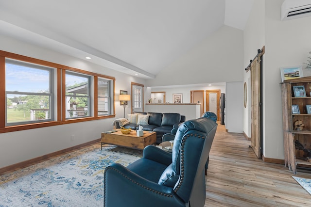 living room featuring baseboards, a wall mounted air conditioner, a barn door, light wood-style floors, and high vaulted ceiling