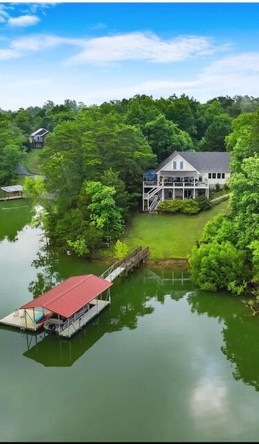 view of dock with a view of trees and a water view