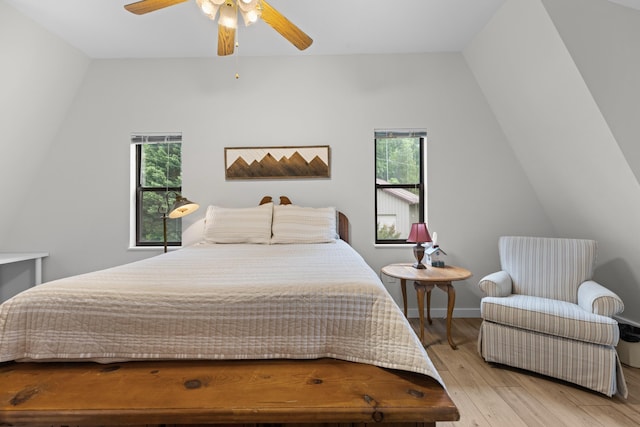 bedroom featuring multiple windows, baseboards, ceiling fan, and hardwood / wood-style flooring