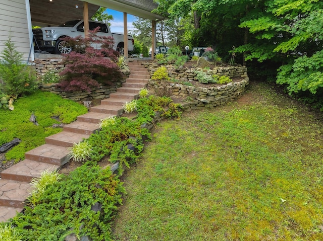 view of yard featuring stairs and a carport