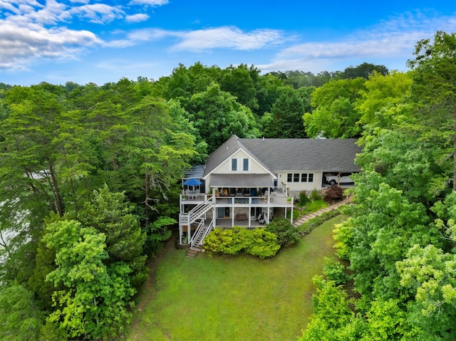 drone / aerial view with a wooded view