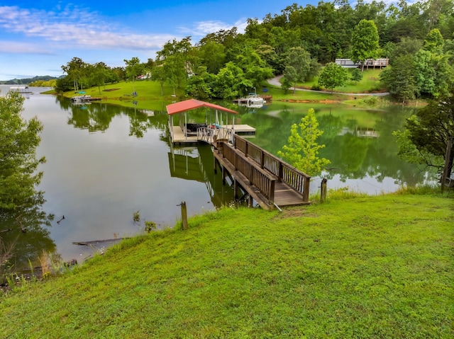 view of dock featuring a yard and a water view