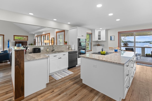 kitchen featuring a peninsula, recessed lighting, black appliances, white cabinets, and light wood-type flooring