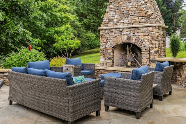 view of patio with an outdoor living space with a fireplace