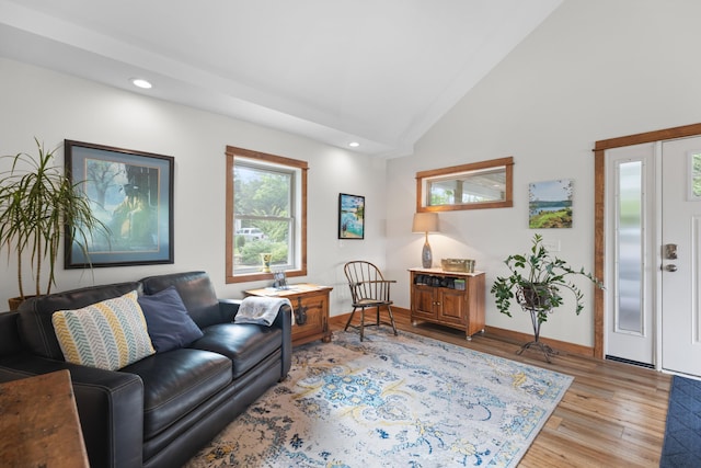 living area with recessed lighting, baseboards, high vaulted ceiling, and light wood finished floors