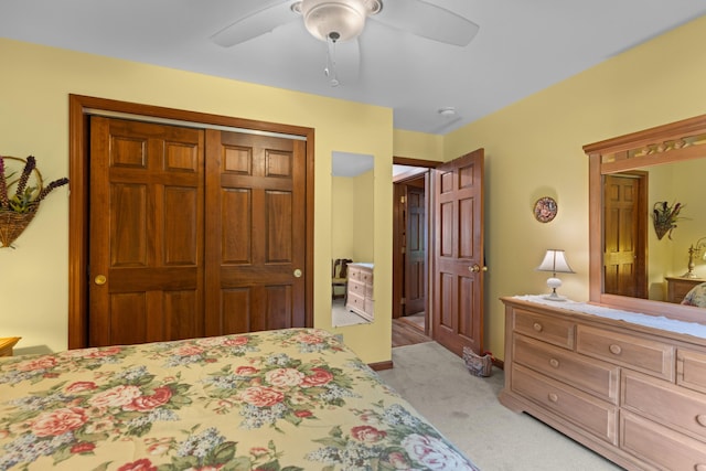 carpeted bedroom with a closet and ceiling fan