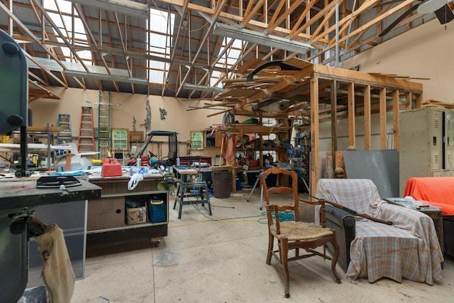 miscellaneous room featuring unfinished concrete floors and a workshop area