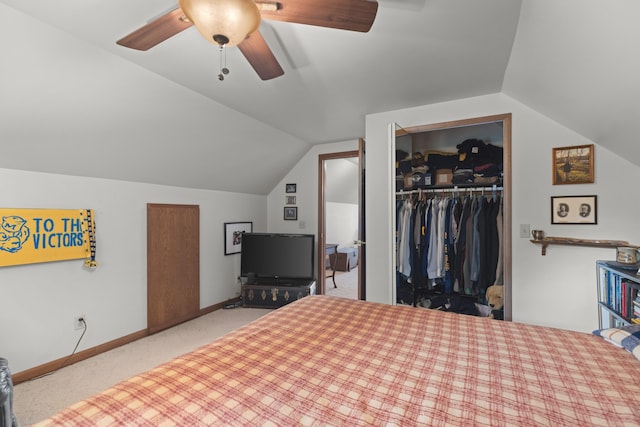 bedroom with vaulted ceiling, baseboards, a closet, and carpet floors