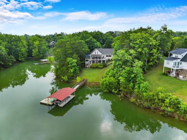 aerial view featuring a forest view and a water view