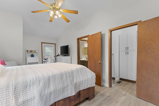 bedroom featuring a ceiling fan, baseboards, light wood finished floors, vaulted ceiling, and connected bathroom