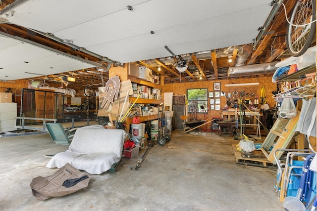 garage with a workshop area and a garage door opener