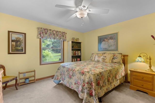 carpeted bedroom featuring a ceiling fan and baseboards