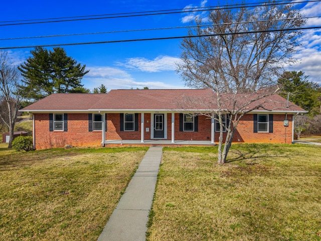 single story home with a front yard and covered porch