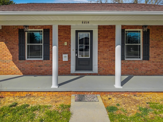 view of exterior entry with a porch