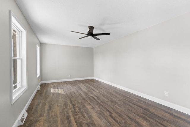 spare room featuring ceiling fan and dark hardwood / wood-style flooring