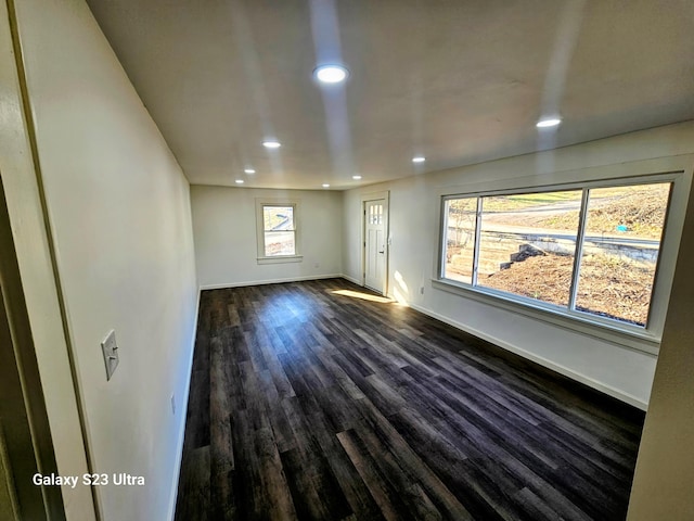 unfurnished room featuring dark wood-type flooring