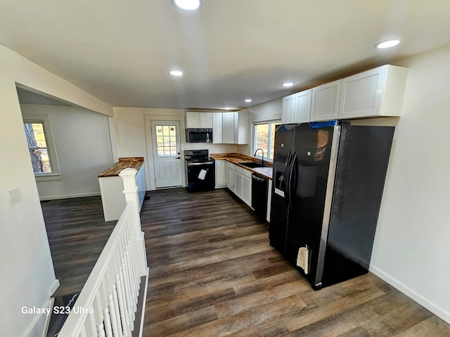 kitchen featuring white cabinetry, sink, black appliances, and dark hardwood / wood-style floors